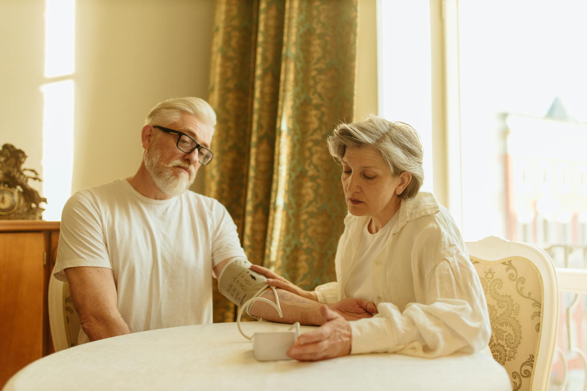 Senior checking blood pressure in the morning