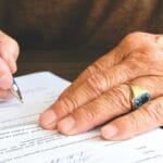 Senior reviewing Medicare claim denial documents