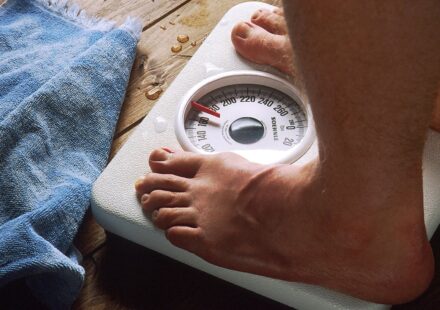 A person standing barefoot on a bathroom scale