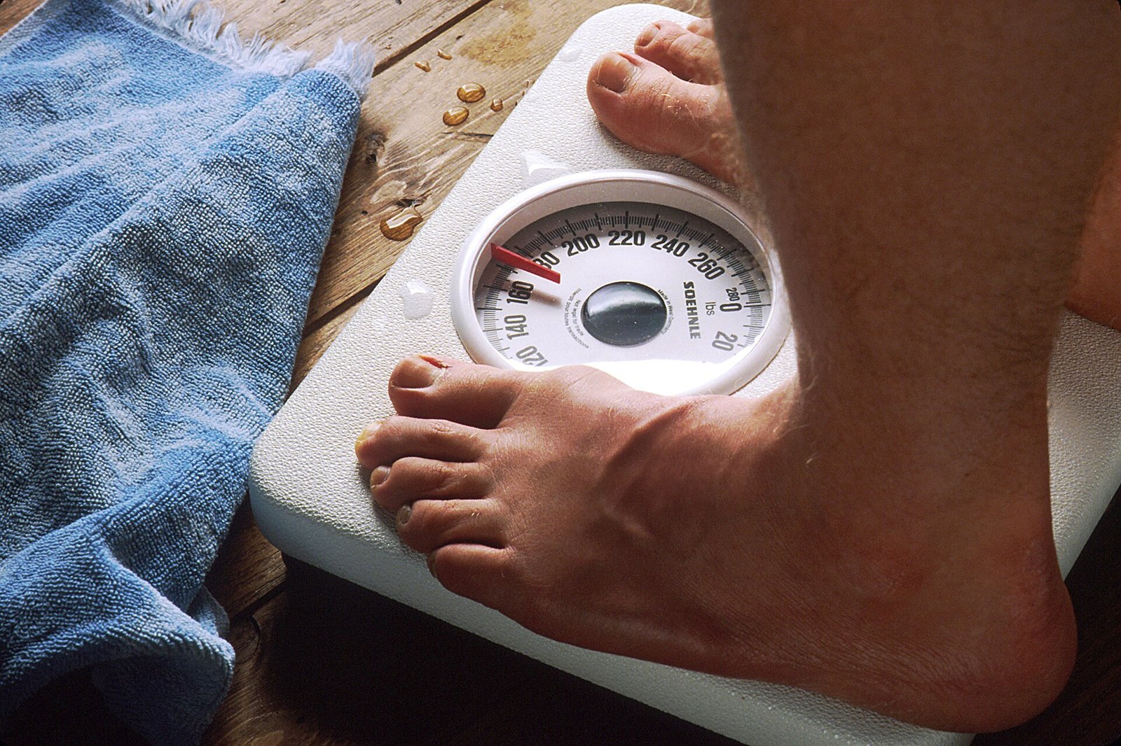 A person's feet on a bathroom scale