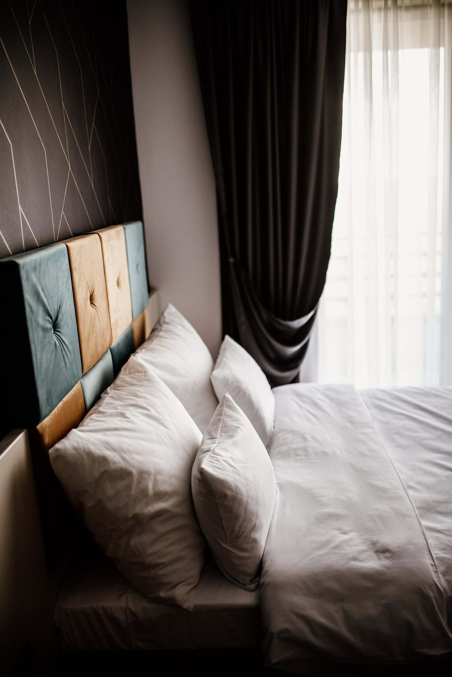 Bright bedroom with plush pillows and drapes