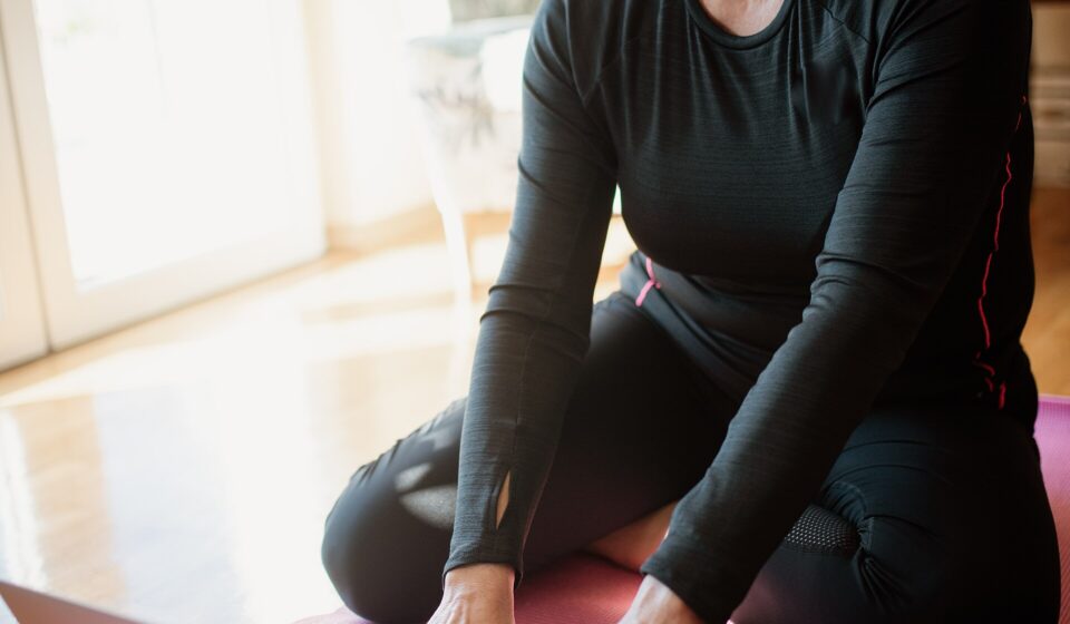 Exercises for Osteoporosis After 60: 9 Safe Moves for Stronger Bones and Fewer Falls (and What to Avoid) Older woman with light dumbbells on an exercise mat at home