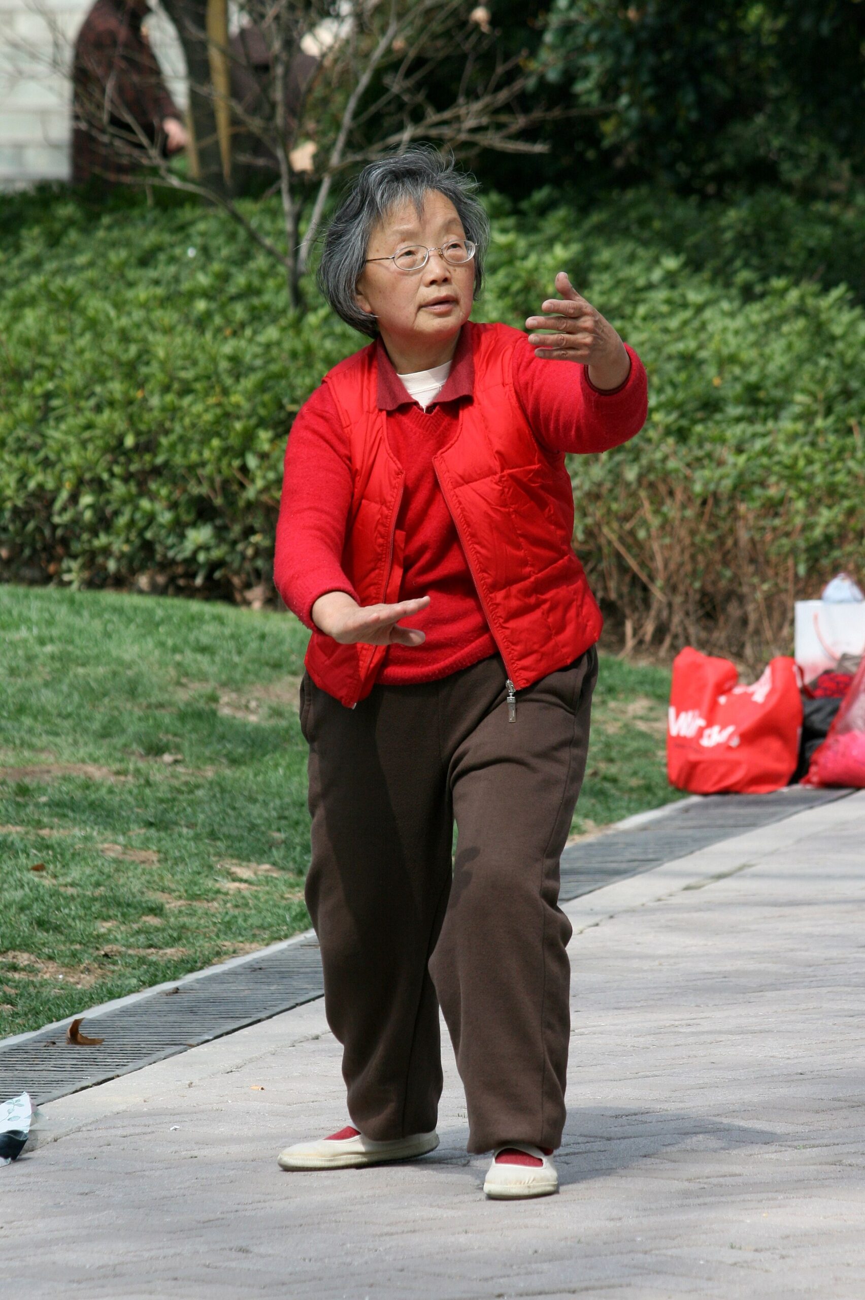 Older woman practicing tai chi outdoors