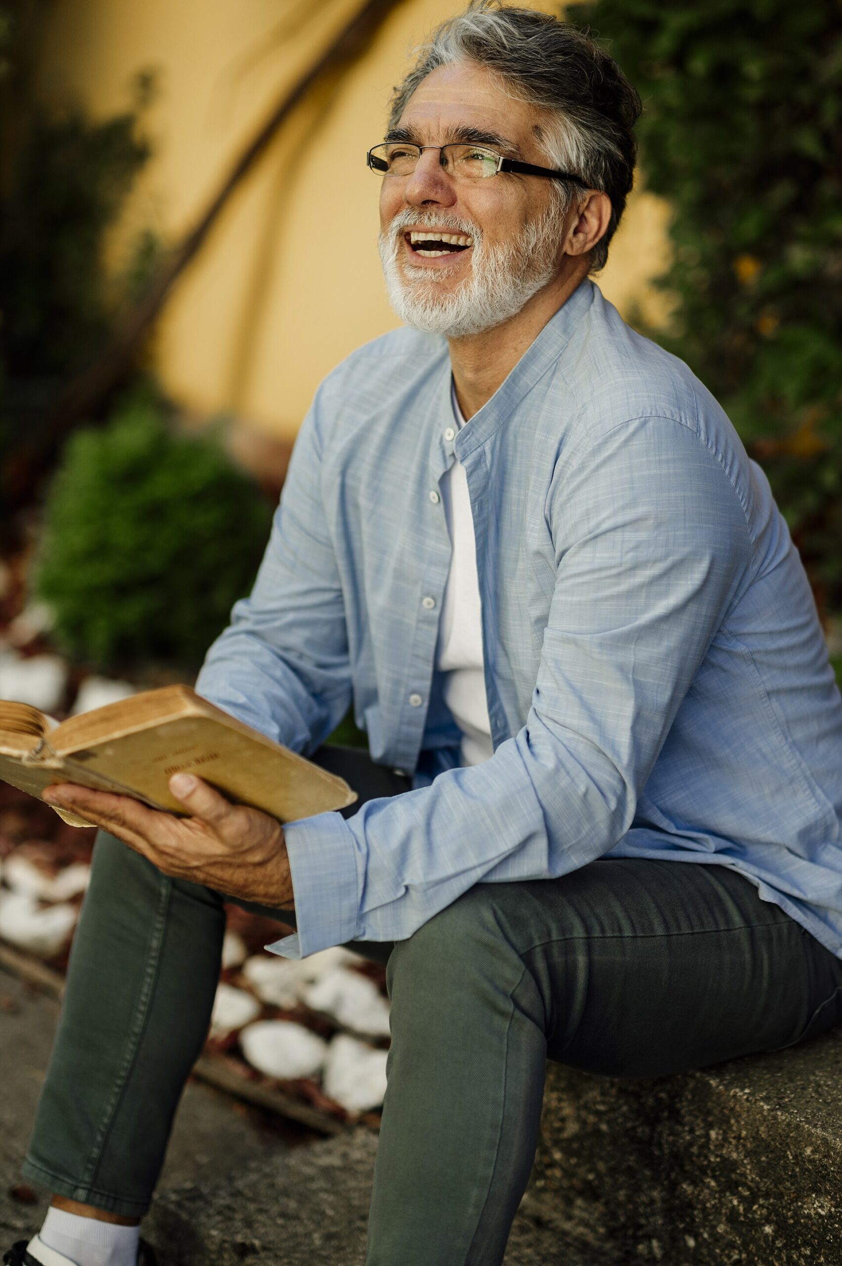 Senior man reading a book and smiling
