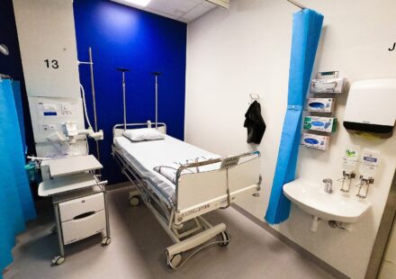 Empty hospital bed in a patient room
