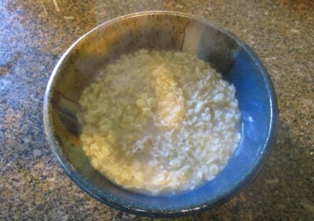 A bowl of cooked oatmeal on a table