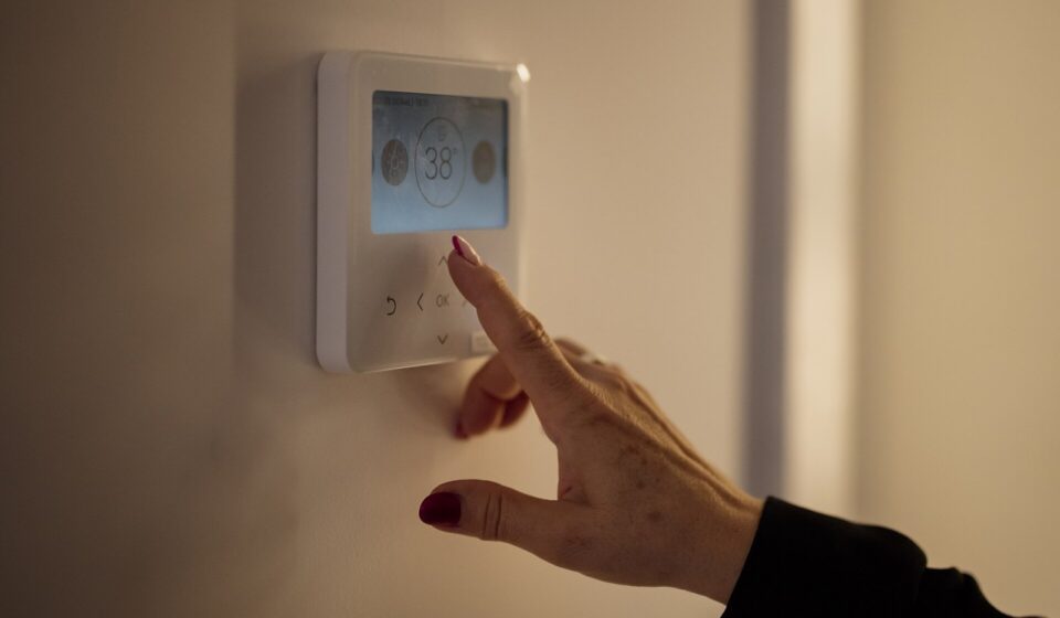 Weatherization Assistance Program for Seniors: Who Qualifies, What It Covers, and How to Apply A hand adjusting the temperature on a home thermostat