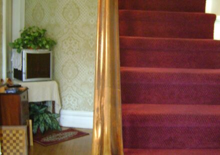 Wooden staircase with a sturdy handrail and banister in a home
