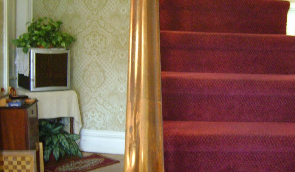Stair Climbing for Seniors: What the Heart Research Shows, How Many Flights Count, and How to Start Safely Wooden staircase with a sturdy handrail and banister in a home