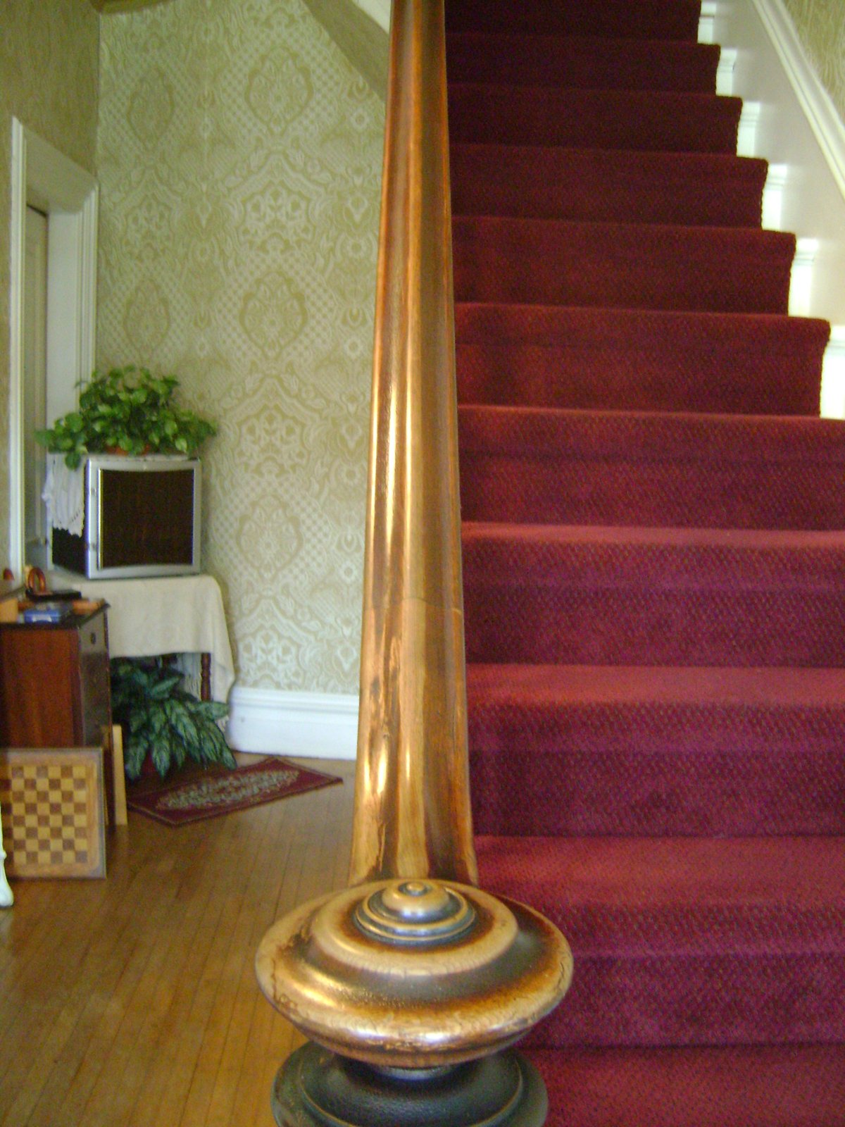 Wooden staircase with a sturdy handrail and banister in a home