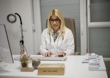 A doctor at her desk in a clinic office
