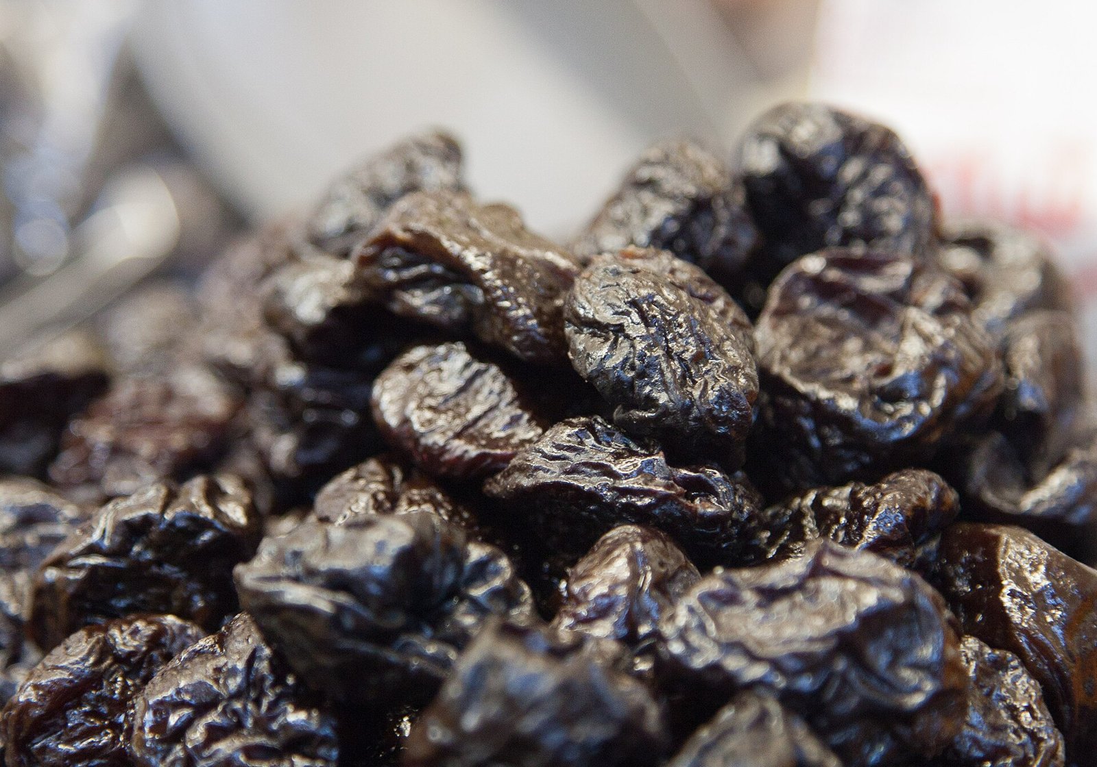 A close-up of a pile of dried prunes