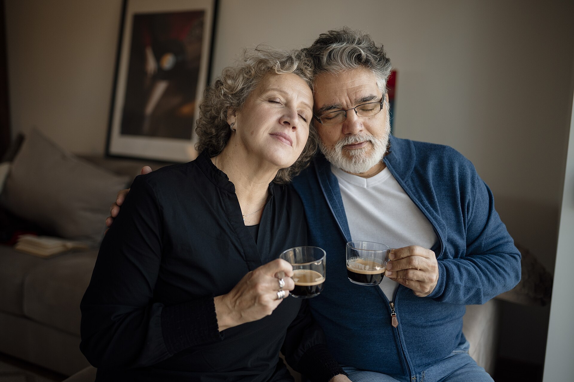 Older couple having coffee together in their living room