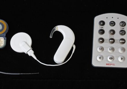 The parts of a cochlear implant system: the internal implant, the behind-the-ear sound processor and a remote control