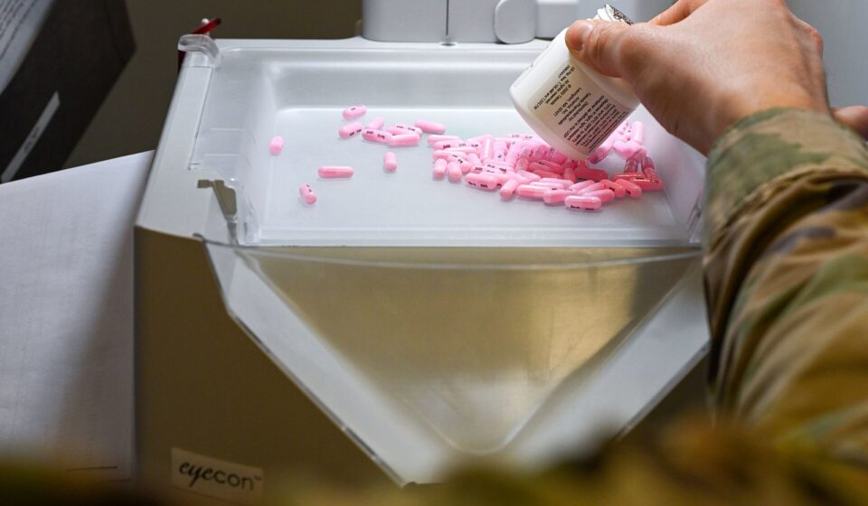 Medicare Drug Price Negotiation Reaches Part B: The 2028 Drug List, the November 30 Deadline, and What It Could Mean for You A pharmacist pours tablets into an automated pill counter while filling a prescription